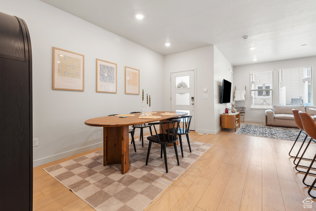 Dining area featuring light wood-type flooring and recessed lighting