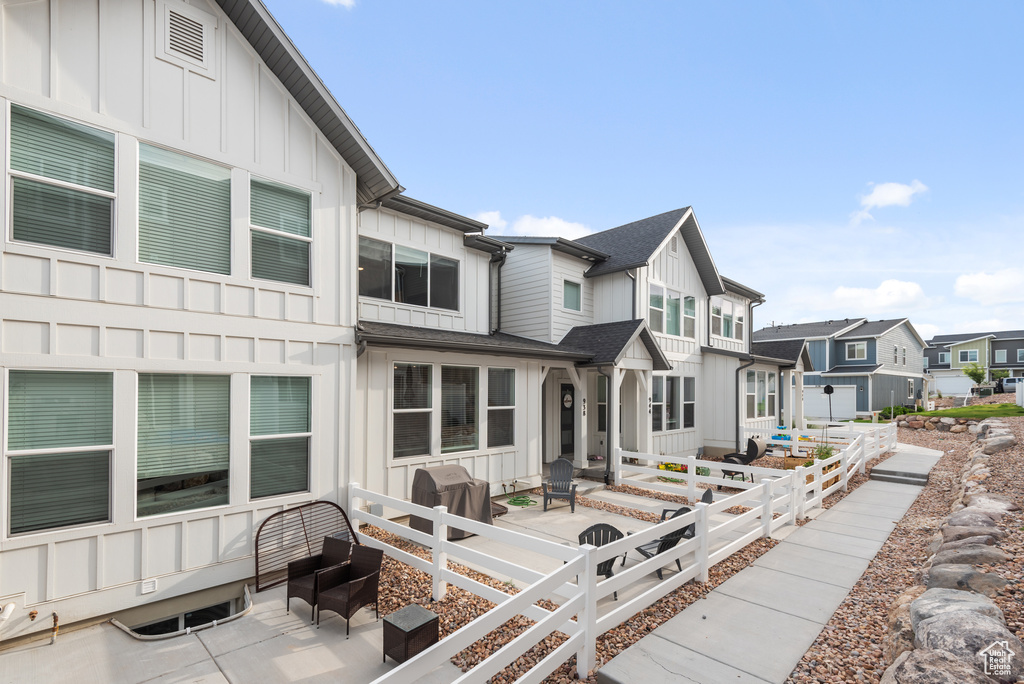 Back of property featuring board and batten siding and a residential view