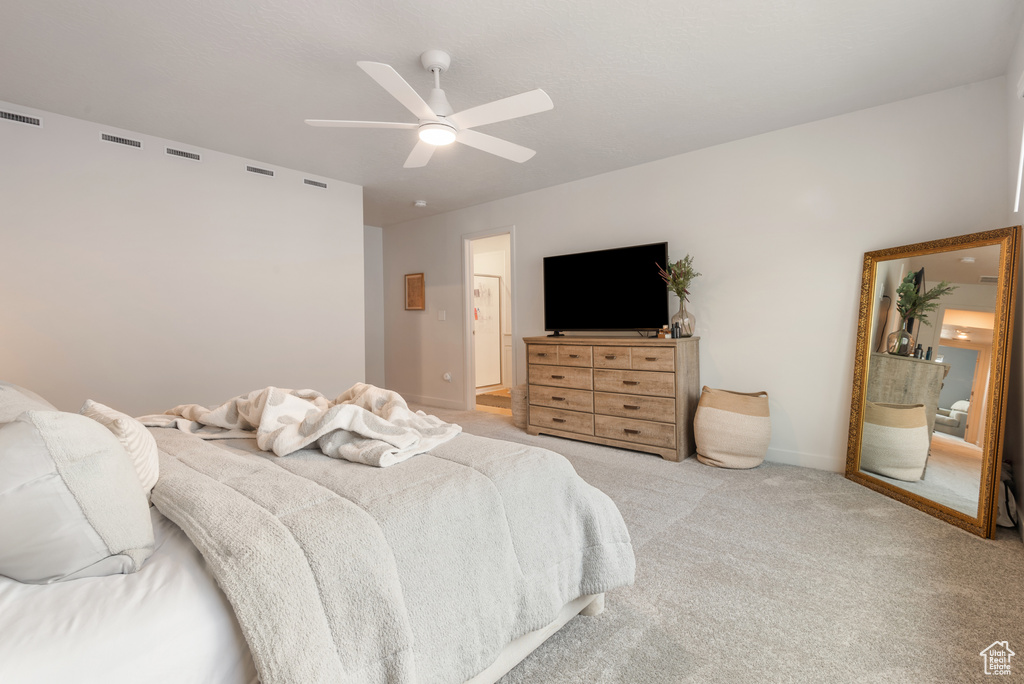 Bedroom with light colored carpet and ceiling fan