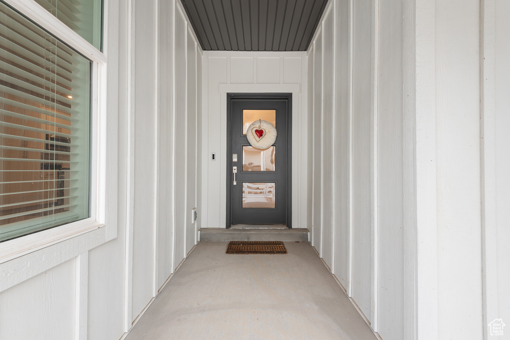 View of exterior entry featuring board and batten siding