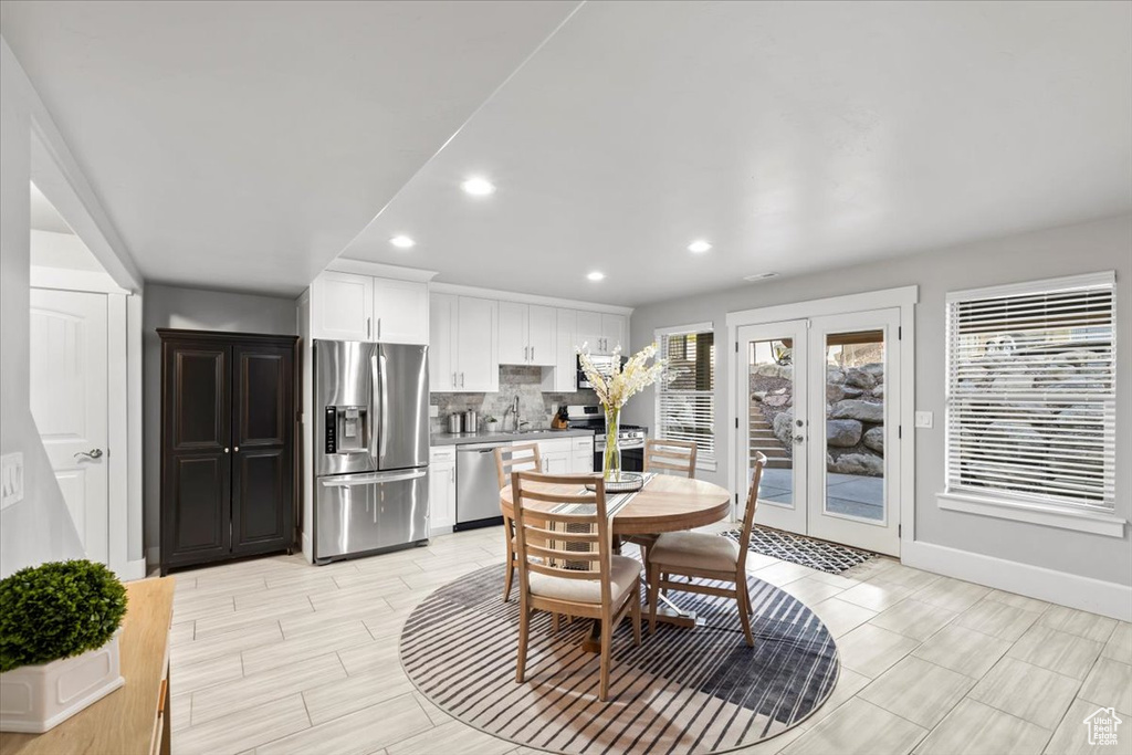 Dining room with french doors and recessed lighting