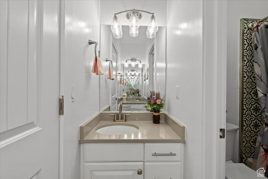 Full bathroom with vanity and a shower with curtain