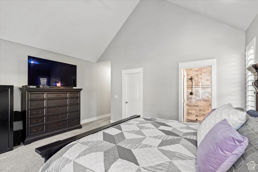 Bedroom featuring carpet and high vaulted ceiling