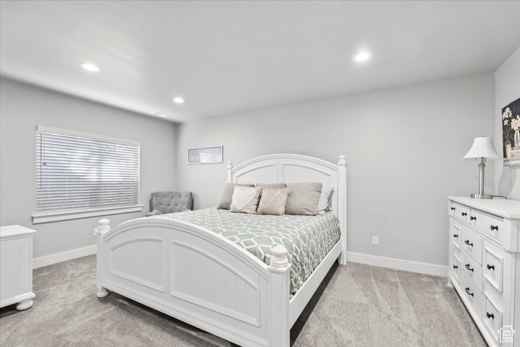 Bedroom with light carpet and recessed lighting