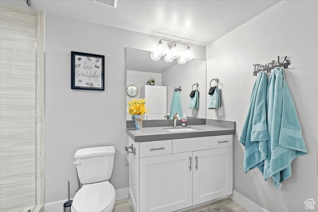Bathroom with vanity and tiled shower