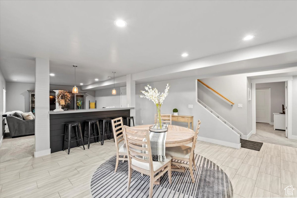 Dining room featuring stairway, recessed lighting, and bar area