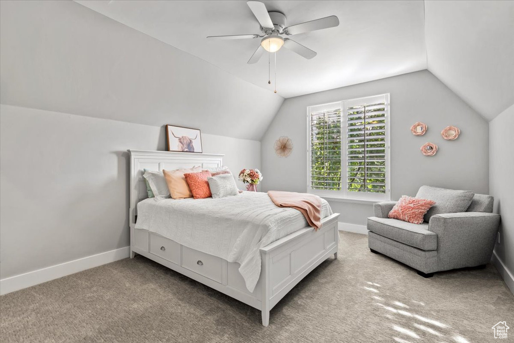 Bedroom with lofted ceiling, carpet flooring, and ceiling fan