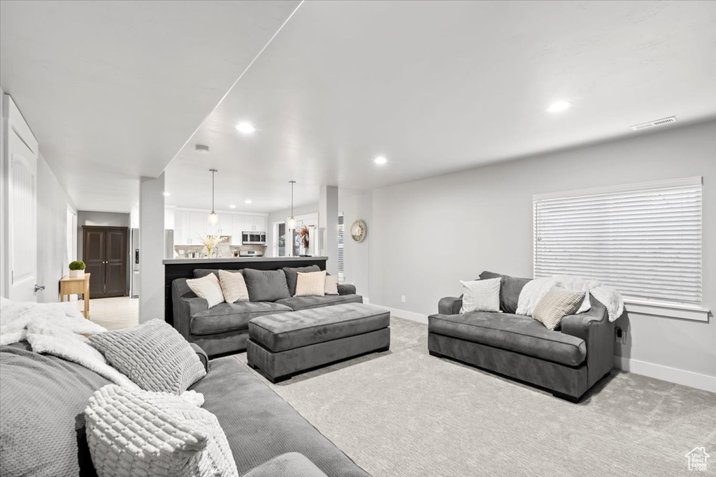 Living room with recessed lighting and light carpet