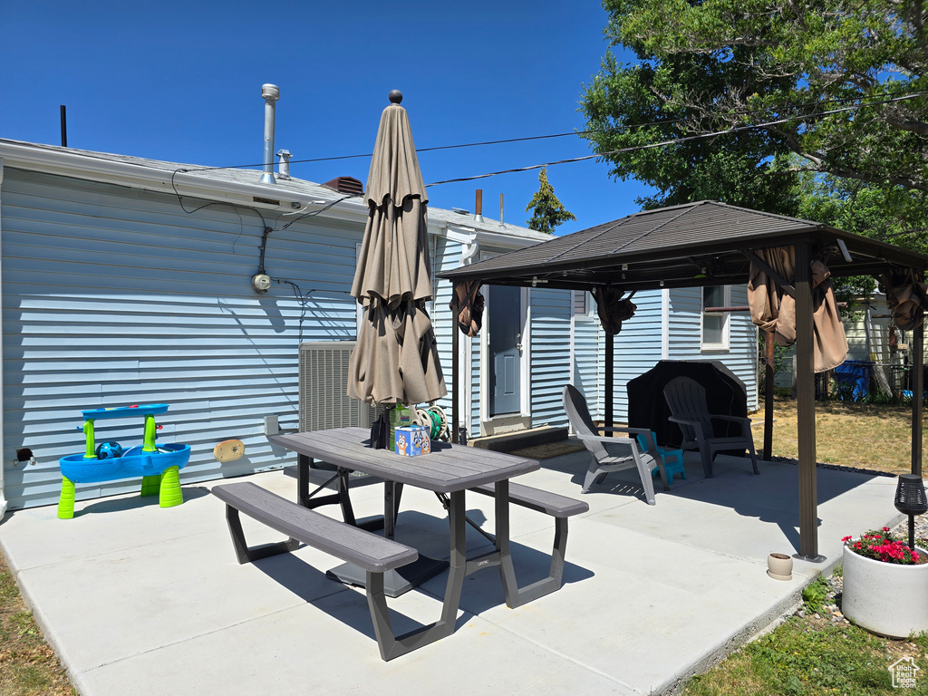 View of patio with a gazebo and outdoor dining space