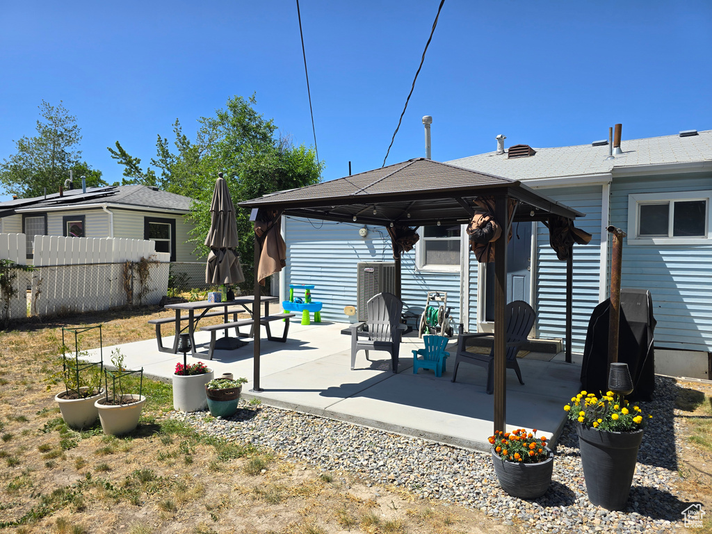 Rear view of property featuring a gazebo and a patio area