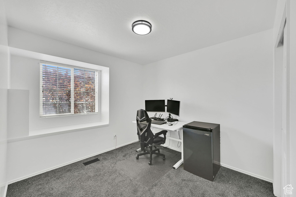 Carpeted office with baseboards