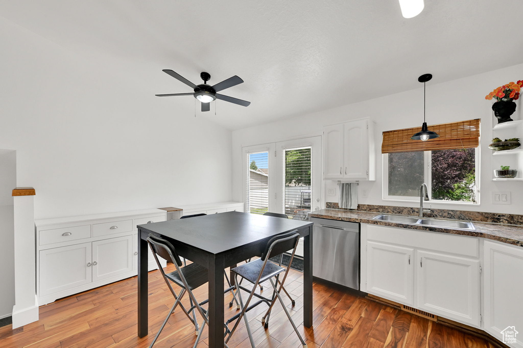 Kitchen with dishwasher, white cabinetry, ceiling fan, and light wood-style flooring