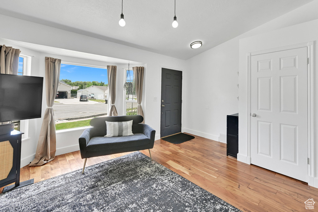 Living area with wood finished floors and baseboards