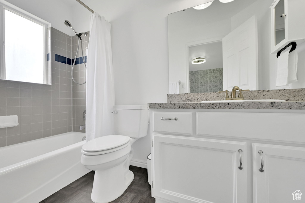 Full bathroom featuring shower / bathtub combination with curtain and vanity