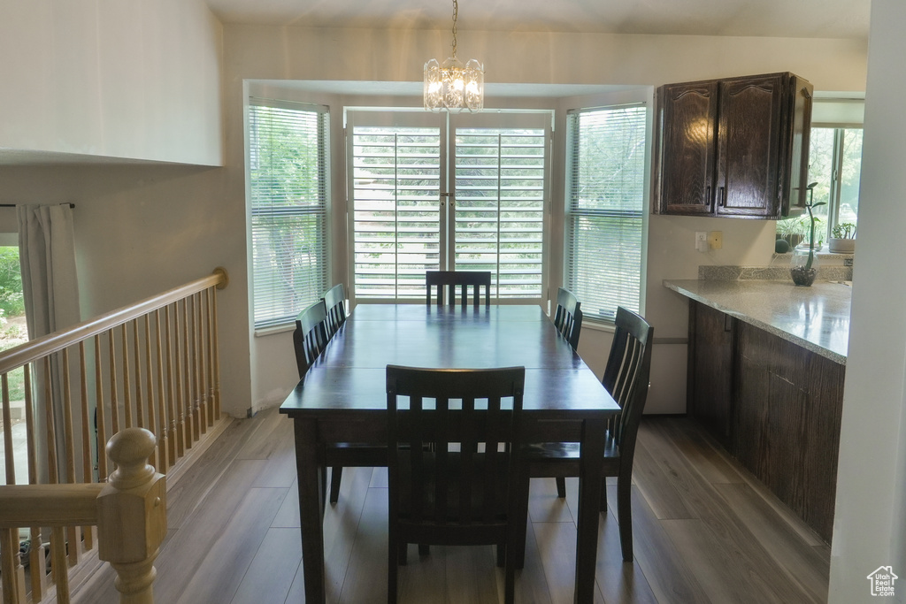Dining space with light wood-type flooring and a chandelier