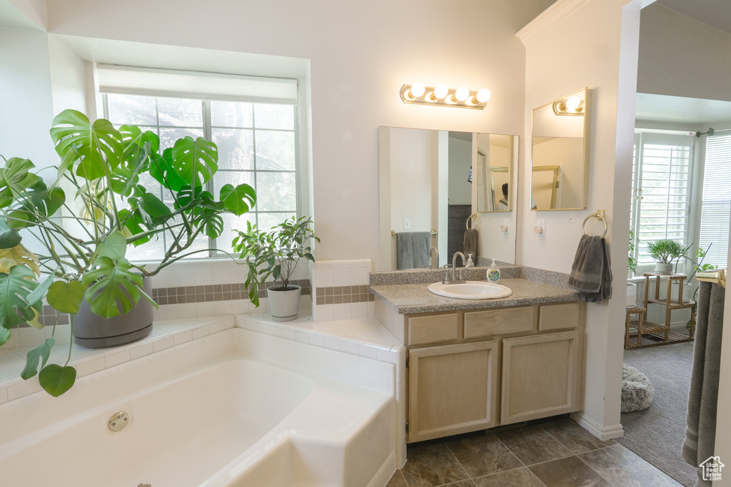 Full bath featuring a garden tub and vanity