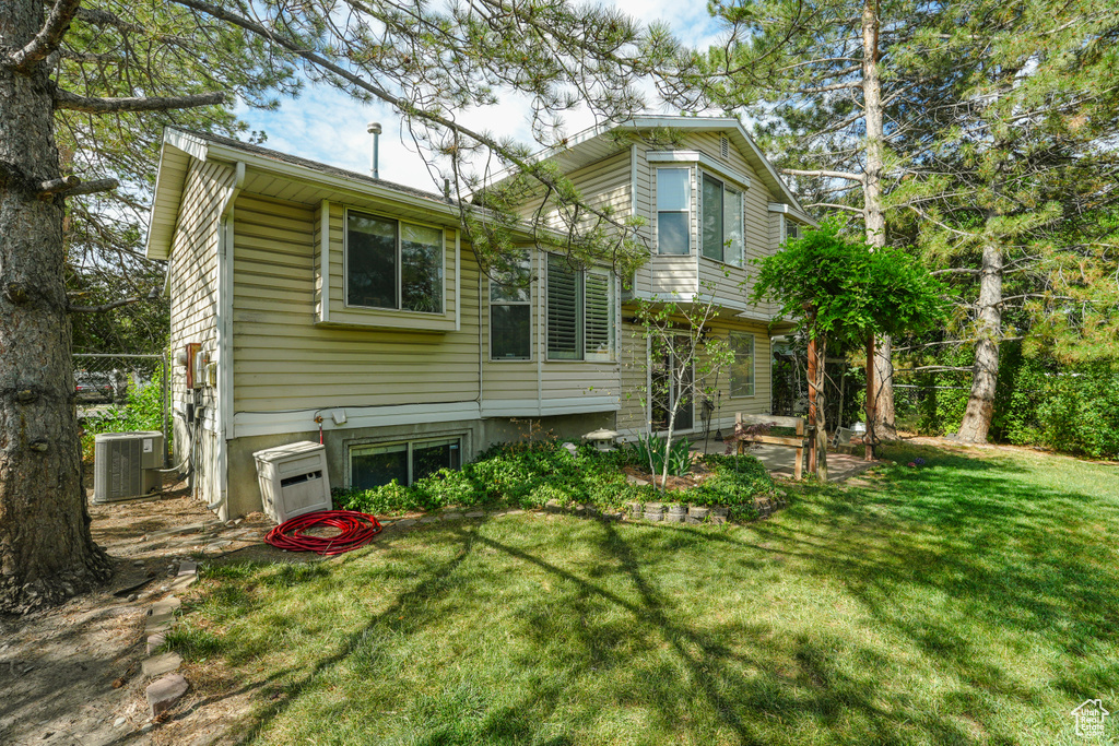 Rear view of house with a yard and a patio