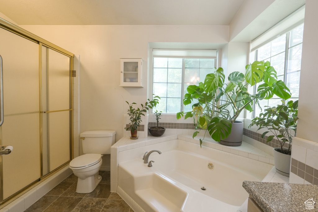 Full bath with a bath and a stall shower