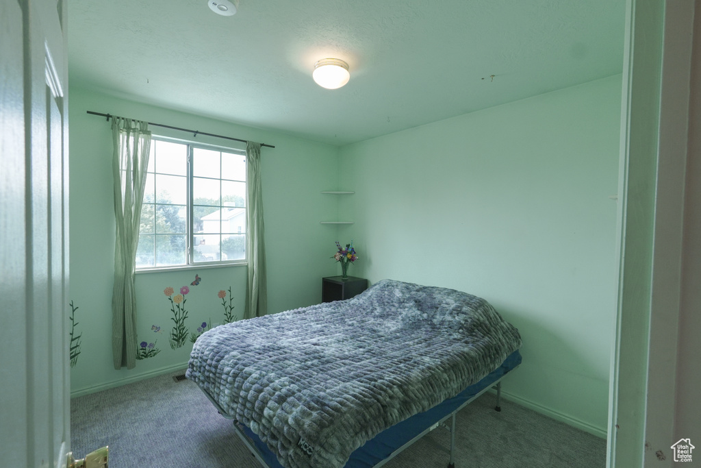 Carpeted bedroom with baseboards