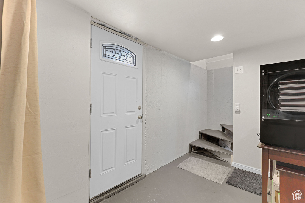 Foyer entrance featuring concrete floors and stairs