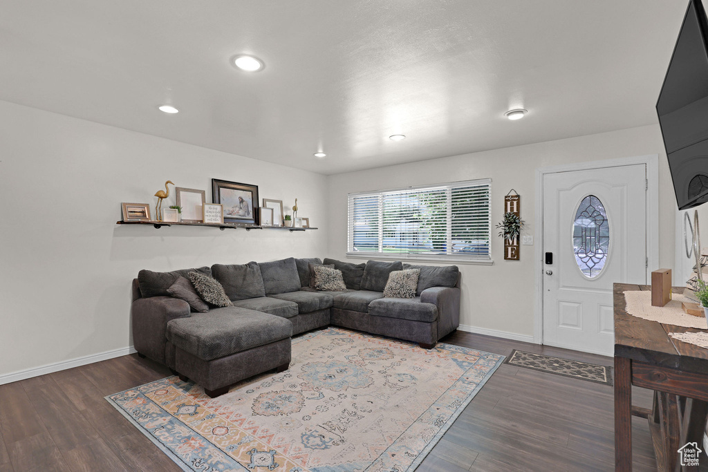 Living area with wood finished floors and recessed lighting