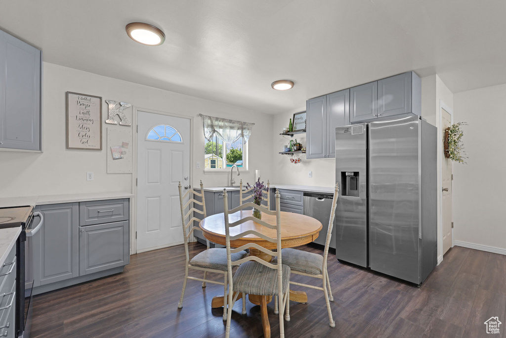Dining space featuring dark wood finished floors and baseboards