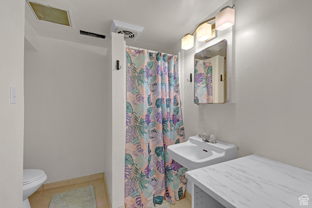Bathroom featuring tile patterned floors and a shower with curtain
