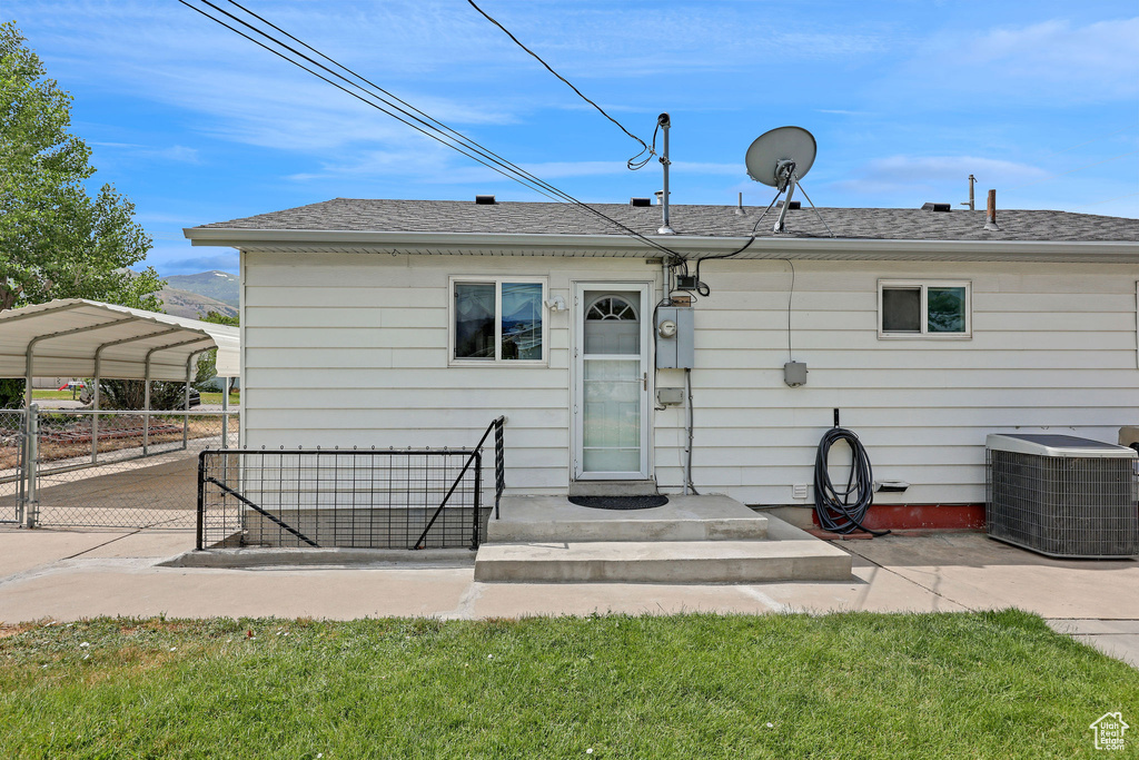 Back of house with a detached carport