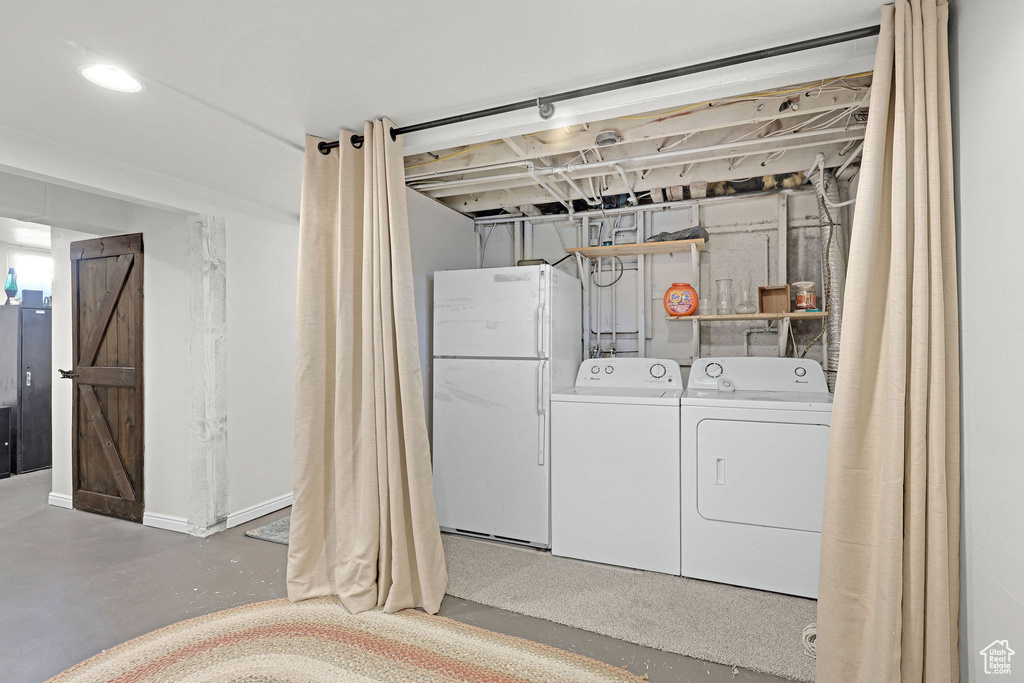 Laundry area featuring washer and clothes dryer and recessed lighting