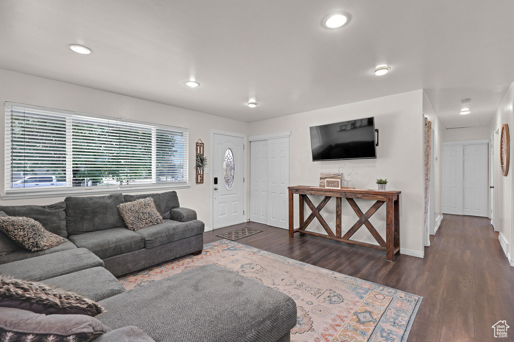 Living area with wood finished floors and recessed lighting