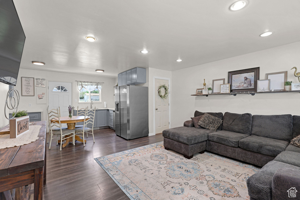 Living area with dark wood finished floors and recessed lighting