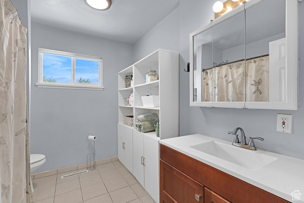 Full bath featuring vanity and tile patterned floors
