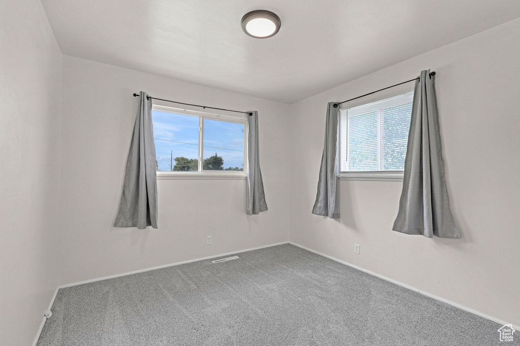 Unfurnished room with carpet flooring and baseboards
