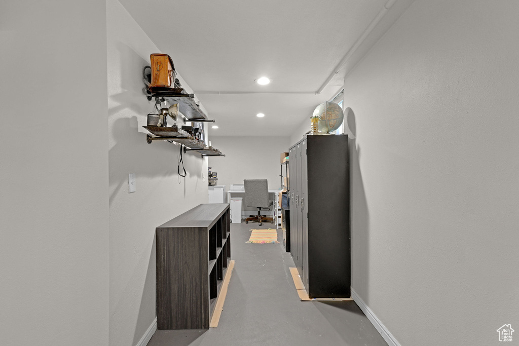 Hall with finished concrete floors and recessed lighting