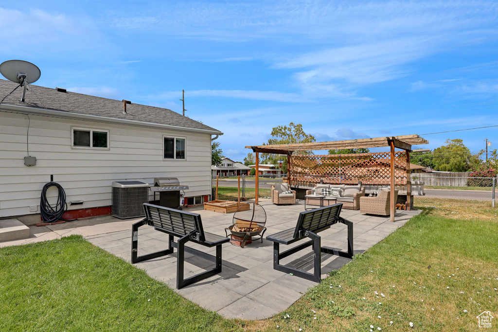 View of patio with an outdoor living space with a fire pit and a pergola