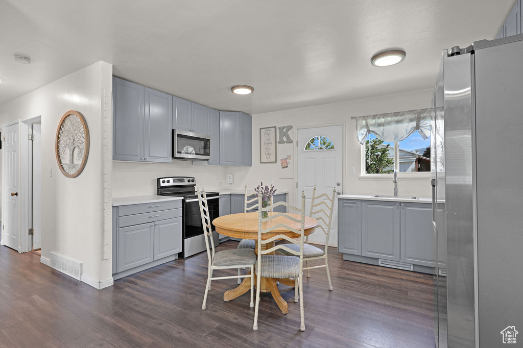 Dining room with dark wood finished floors and a barn door