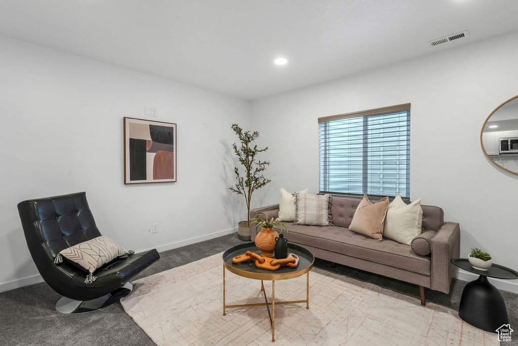 Living area with carpet flooring and recessed lighting