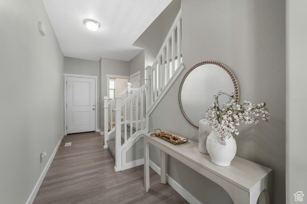 Entryway featuring stairway and wood finished floors