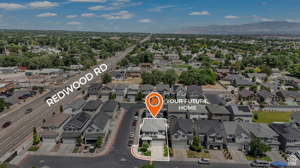 Aerial view of residential area featuring a mountain backdrop