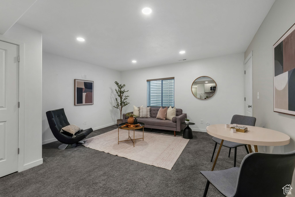 Carpeted living area featuring recessed lighting