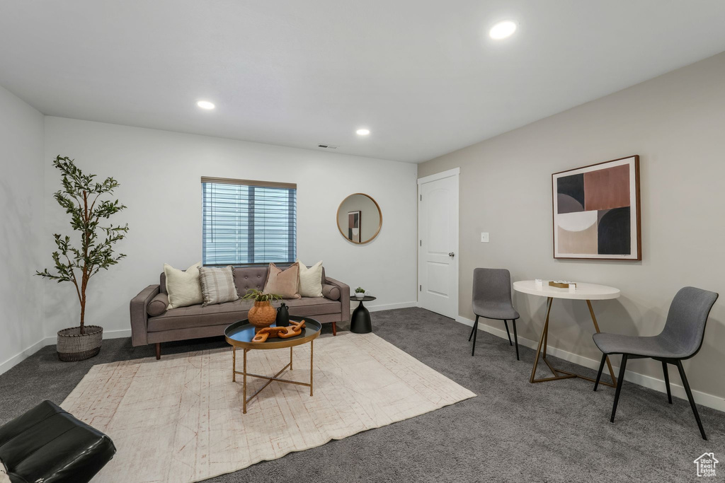 Living area with carpet floors and recessed lighting