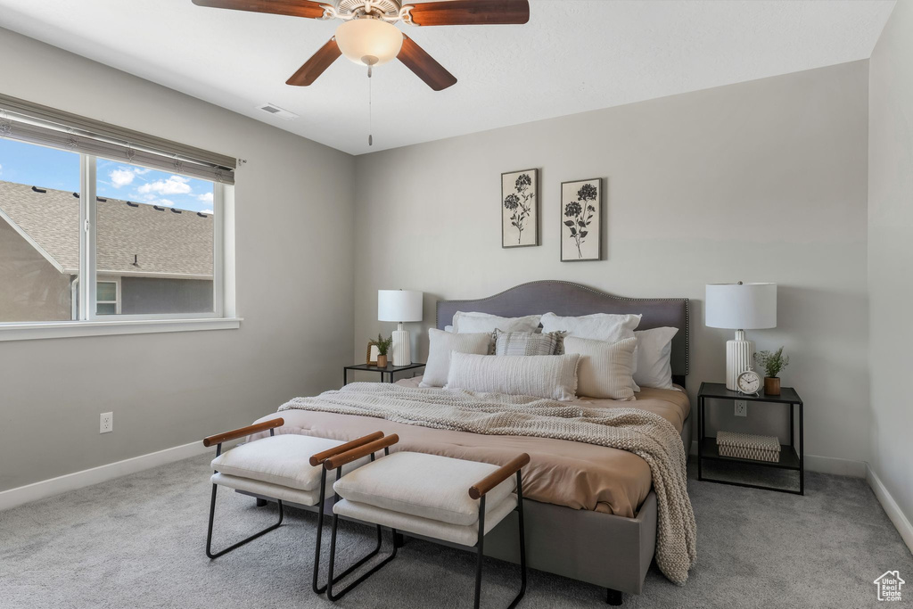 Carpeted bedroom featuring baseboards and ceiling fan