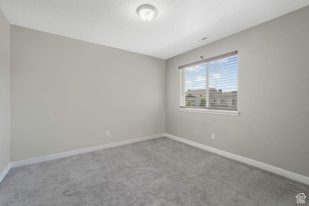 Spare room featuring carpet floors