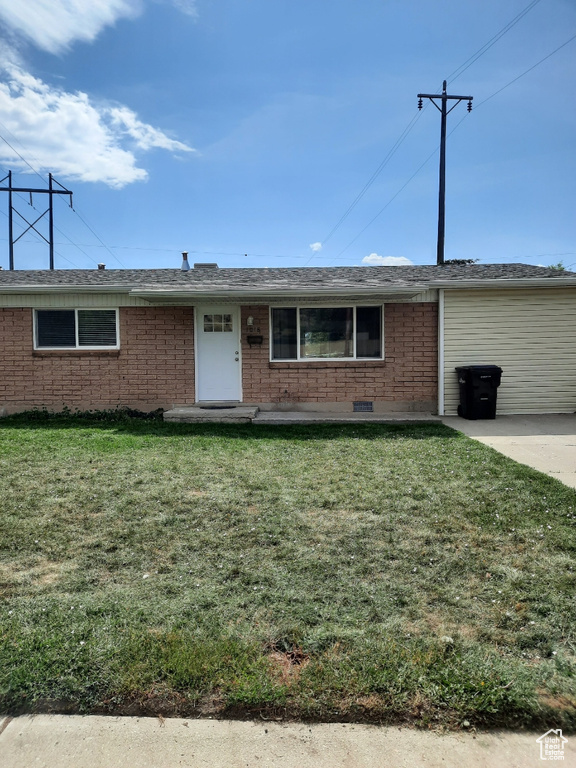 Ranch-style home with a front lawn and brick siding