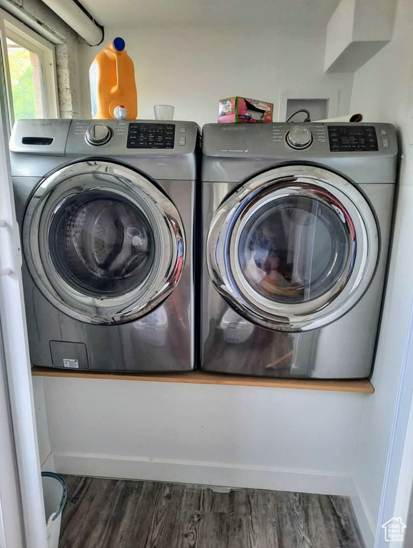 Laundry room with wood finished floors and separate washer and dryer