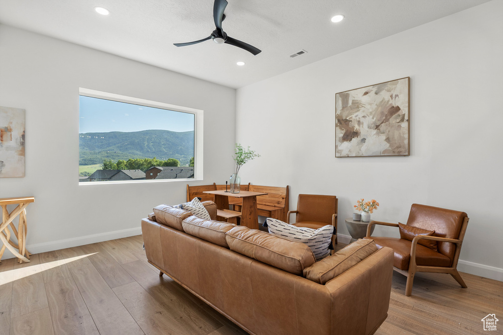 Living area featuring a ceiling fan, wood finished floors, recessed lighting, and a mountain view