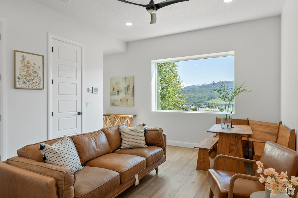 Living area with light wood-style flooring, recessed lighting, a ceiling fan, and a mountain view