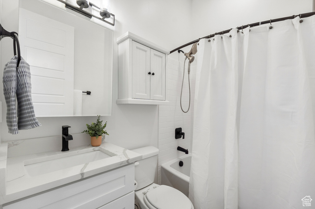 Full bath featuring vanity and shower / bath combo with shower curtain