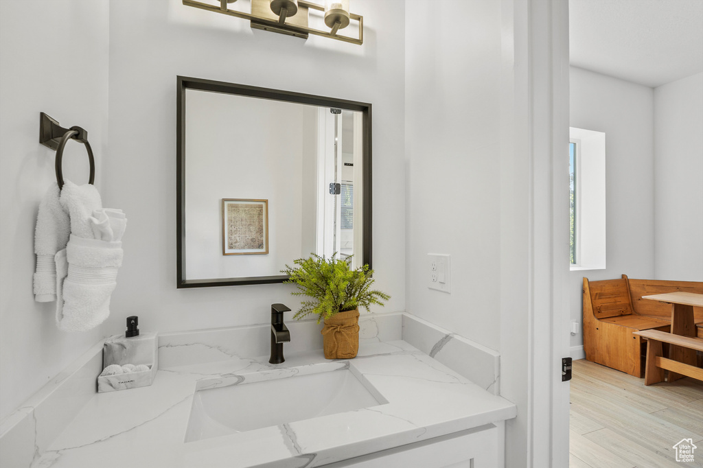Bathroom featuring vanity and wood finished floors