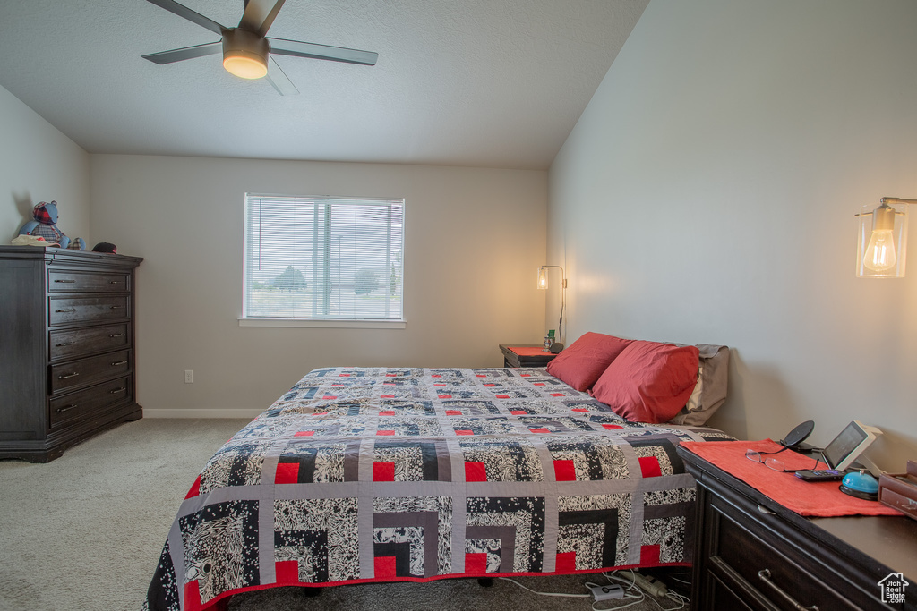 Bedroom featuring light colored carpet and a ceiling fan